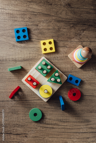 Colorful Educational Toys for Child Development on Wooden Surface
