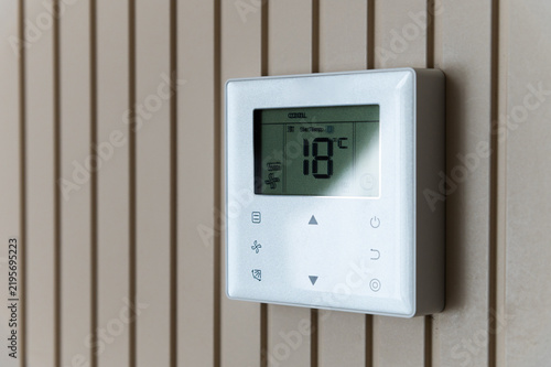 Digital Climate Control Thermostat Mounted On Slatted Wall