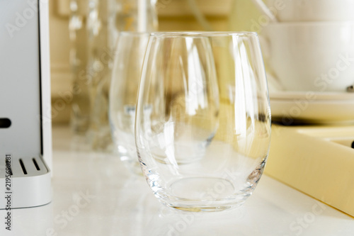 Empty glass tumbler on white kitchen counter