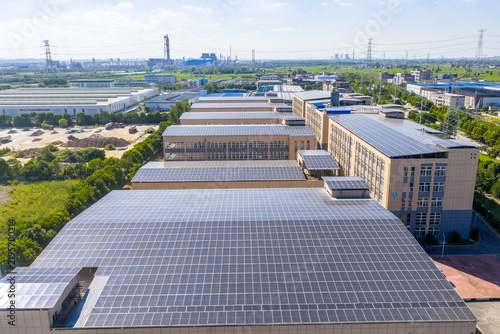 Obraz na plátně Solar panels installed on industrial factory building rooftops for clean energy