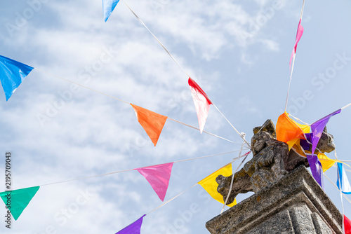 Canvastavla Colorful pennant bunting tied to stone cross The Concept of traditional festival