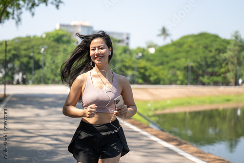 Cuadro en lienzo Woman Jogging Outdoors Along Park Pathway With Nature Scenery and Body Fitness i