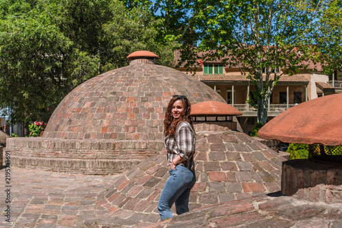 фотографія Beautiful young Caucasian brunette woman posing on the brick domes of sulfur bat