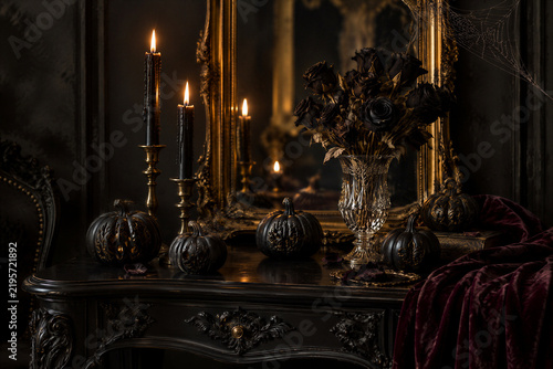 Luxury Halloween still life with black pumpkins, candles and roses on vintage vanity table