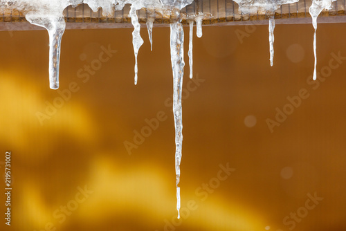 Принти на полотні Ice icicles hang from a metal ledge