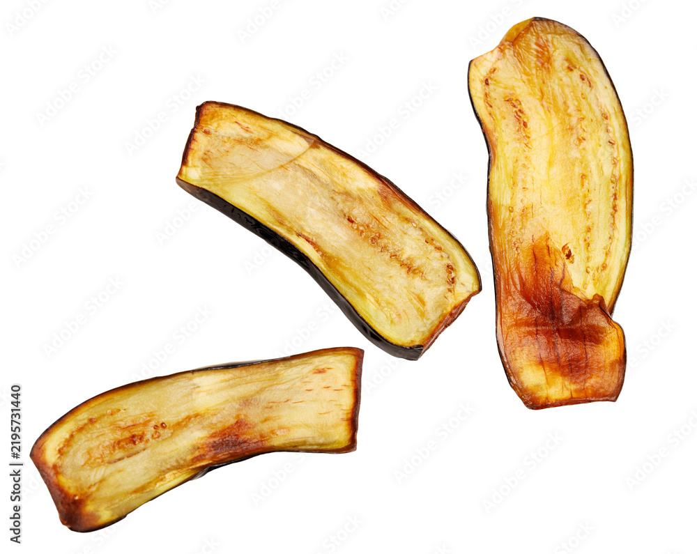 Obraz premium Slices of fried eggplant stand isolated against a white background. The edges are charred, while the interior is soft and golden.