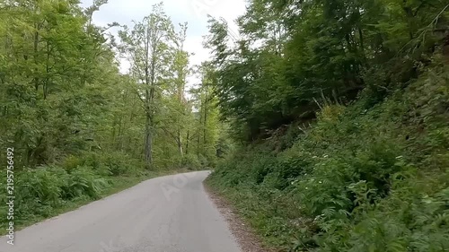 Driving a car along an empty scenic mountain road without traffic. Point of view shot. 