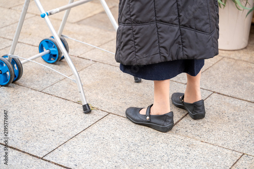 Canvastavla Senior woman walking outdoors using a wheeled walker for mobility and support