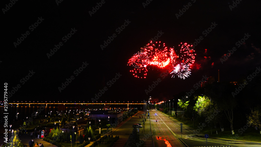 Fototapeta premium Fireworks over a bridge at night.