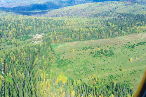 Aerial view from the window of a helicopter on the autumn forest