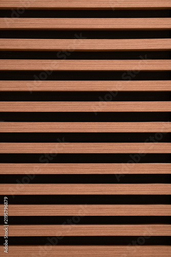 Horizontal wood planks with dark spaces creating a repeating natural design, providing a modern and organic texture for various architectural and decorative applications