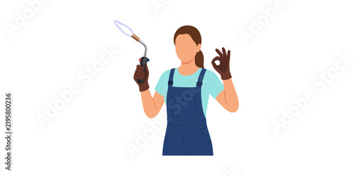 Woman welder wearing overalls holding a blowtorch and making an okay sign gesture