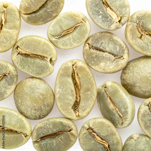Raw Green Coffee Beans with Visible Center Cut on White Background
