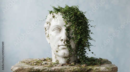 Classical stone head sculpture partially covered with green ivy sits on a stone pedestal.