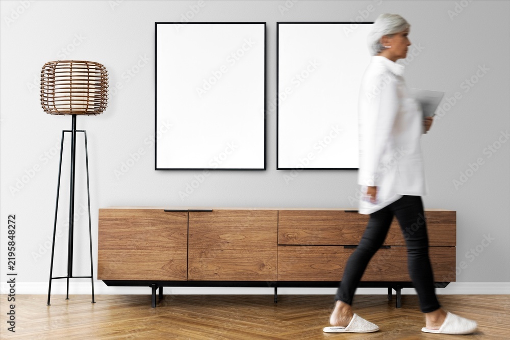 Obraz premium Modern minimalist interior with walking woman and blank frames