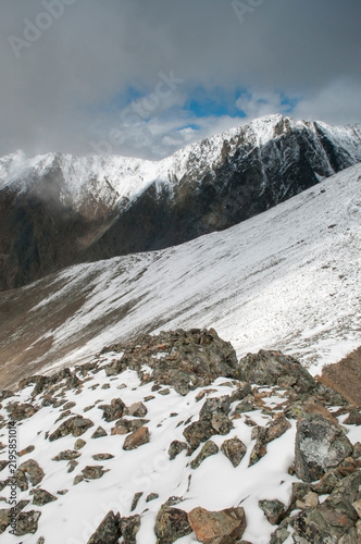 Snow-covered Altai wilderness seen from the top of Pyramid mountain in August, the Altai Republic, Russia