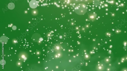 Abstract glowing bokeh particles floating on green screen background