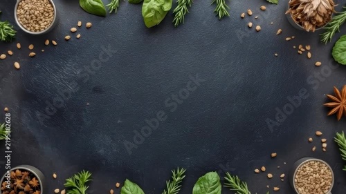 Rustic Herb Spice Border with Basil Bowl on Dark Slate Background Surface
