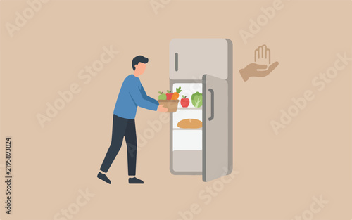Man placing fresh vegetables into a household refrigerator