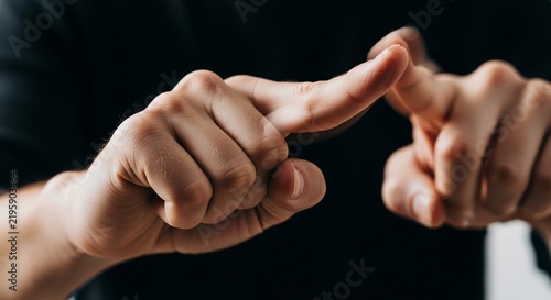Close-up view of two hands forming a gesture, highlighting communication and expressive human movement