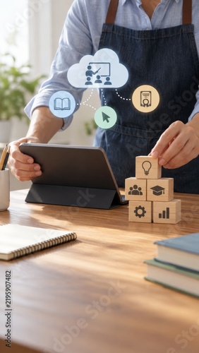 Professional education online e learning platform with digital tools and wooden blocks strategy development icons on table.