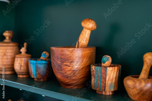 Konstfotografi Handcrafted wooden mortars and pestles sit on a dark shelf in a souvenir shop in Kerkira, Greece