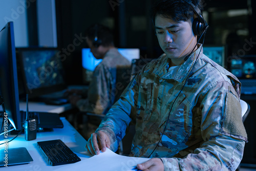 Engineers logistics operator using GPS radar and real-time fleet management dashboard on computer.