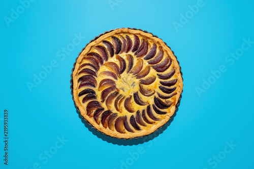 Caramelized onion tart with blue cheese on a blue backdrop