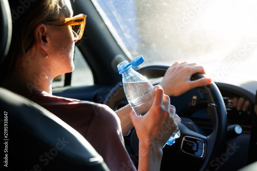 Canvas Print Woman Driver Holds Water Bottle for Summer Car Hydration