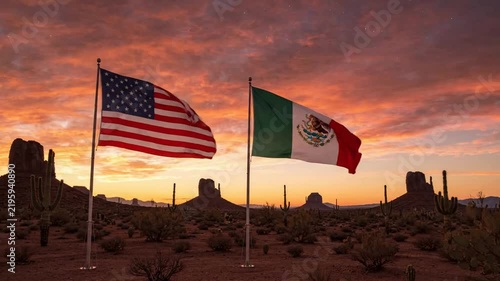Usa and mexico flags waving together in desert landscape at sunset international relations and border concept