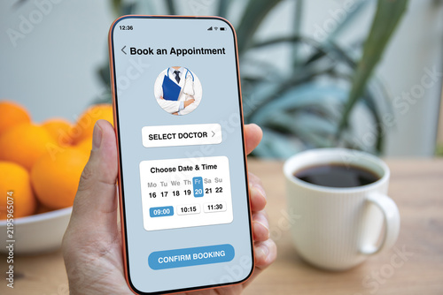 Man holding phone with medical doctor appointment booking app interface