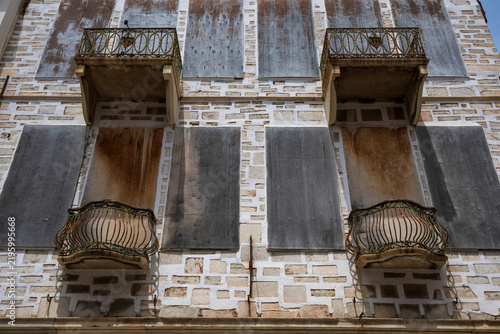Weathered balconies and shuttered windows, Syros, Greece