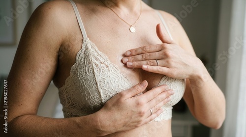 Woman Performing Breast Self-Exam For Health Awareness