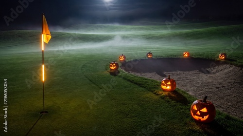 Spooky Halloween Night Golf Course with Glowing Pumpkins and Misty Landscape Under Full Moon