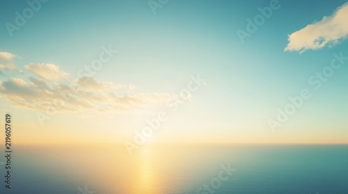 Stunning golden sunrise over calm ocean horizon with soft clouds blue sky background for nature peaceful meditation wallpaper high resolution
