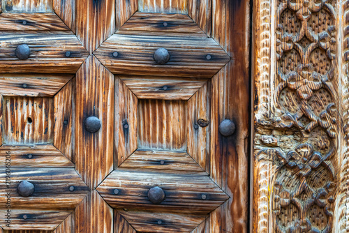 Antique wooden door with metal studs and intricate carvings in the historical district of Istanbul Turkey