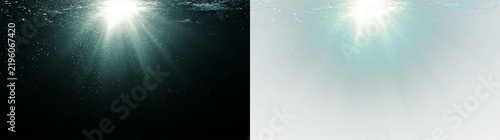 Bild auf Leinwand Sun rays penetrating underwater surface in the deep ocean