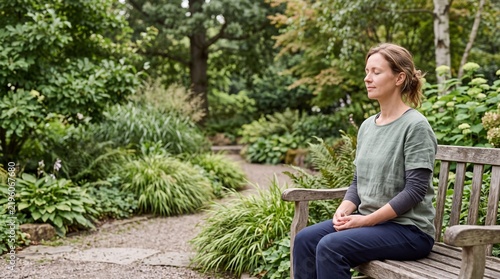 Woman practicing mindfulness meditation in a peaceful garden