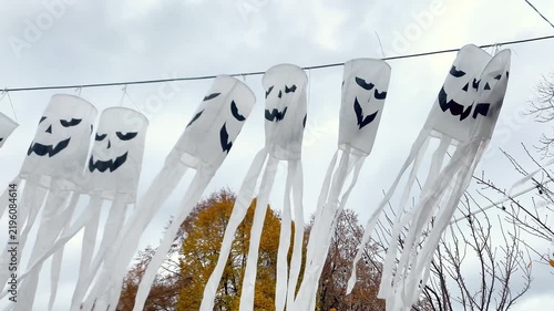 Spooky scary ghosts monster faces lanterns waving on wind on halloween background,autumn holidays,decoration and party concept