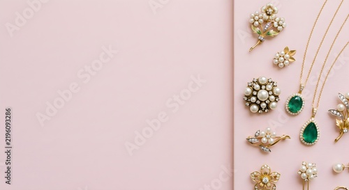 Luxury Gold Jewelry Pieces with Green Emeralds Arranged on Soft Pink