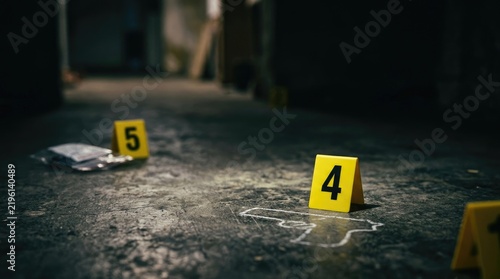 A dark, gritty scene depicts a crime scene. Yellow numbered cones mark a chalk outline of a body on a concrete floor.