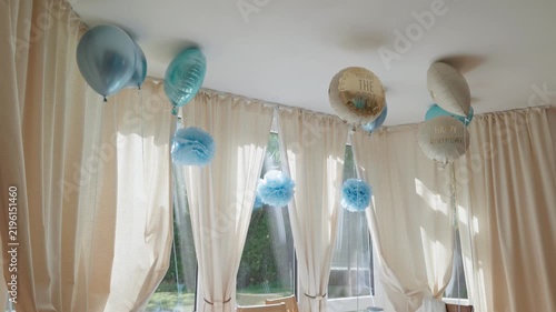 Decorated birthday dining table with balloons bay window interior downward and upward camera movement. Inscriptions on the balloons You are the best and Happy Birthday