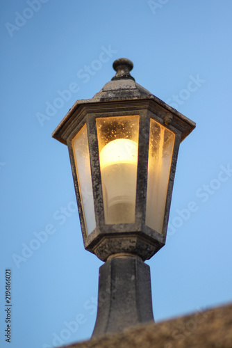 Traditional Vintage Lamp on Stone Wall with Blue Evening Sky