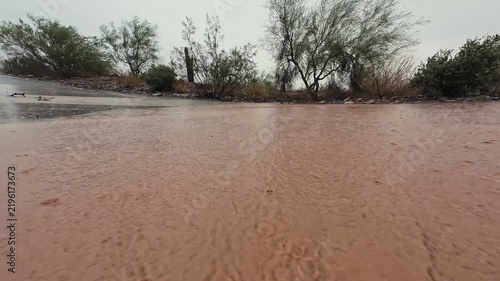 Low Angle View Of AZ Monsoon Storm Water Flowing & Flooding Over Road