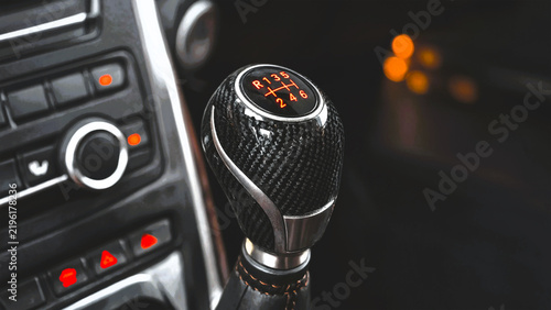 Carbon fiber manual gear shifter in a modern sports car interior