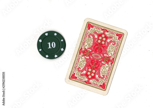 Photography A vintage playing card and poker chip isolated on a white background