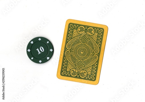 Photography A vintage playing card and poker chip isolated on a white background