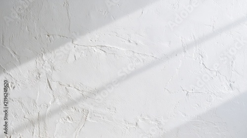 Bright white plaster surface with irregular texture and subtle tonal variation