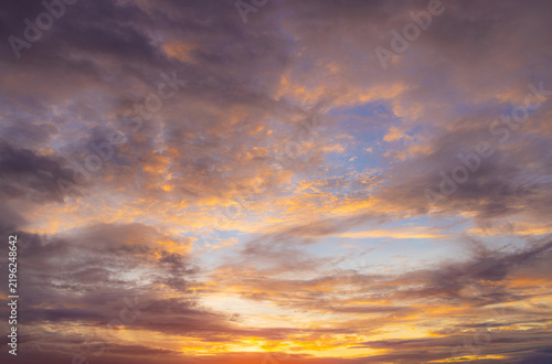 Vibrant Sunset Sky Panorama with Colorful Orange Pink and Blue Clouds,A panoramic photograph capturing a vibrant sunset sky filled with wispy cirrus clouds illuminated in golden yellow, orange, pink, 
