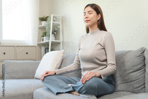 Quadro su tela Women practice her mindfulness by meditation at home.